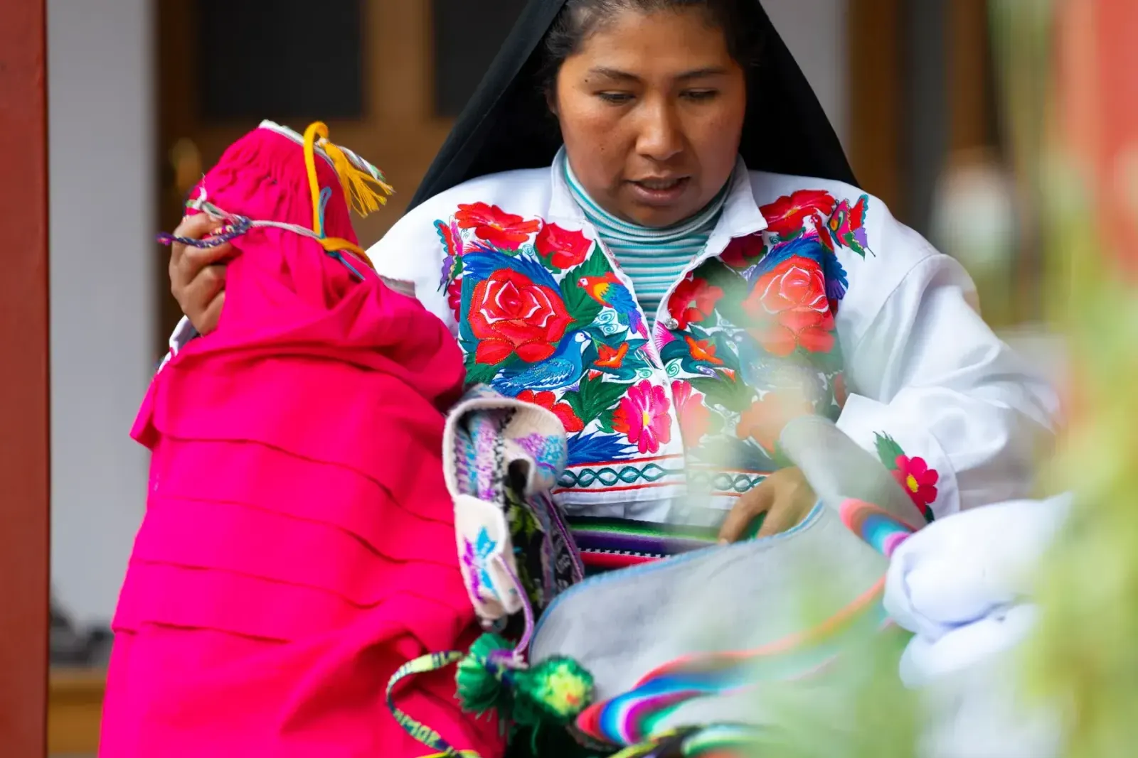 Anfitriona mostrando los textiles bordados de la isla